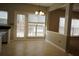 Bright kitchen with tile floors, granite countertops, a large window, and an open design leading to the living room at 3936 Toccoa Falls Dr, Duluth, GA 30097