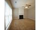 Cozy living room with a fireplace and large window providing ample natural light at 3936 Toccoa Falls Dr, Duluth, GA 30097