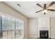 Comfortable living room features a fireplace, ceiling fan, and large windows for natural light at 3936 Toccoa Falls Dr, Duluth, GA 30097