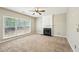 Cozy living room with a fireplace, neutral carpet, and abundant natural light at 3936 Toccoa Falls Dr, Duluth, GA 30097