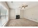Bright living room with a fireplace, ceiling fan, and large windows with blinds for privacy at 3936 Toccoa Falls Dr, Duluth, GA 30097