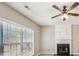 Comfortable living room featuring a fireplace, ceiling fan, and large windows providing natural light at 3936 Toccoa Falls Dr, Duluth, GA 30097