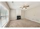Spacious living room with a fireplace, plush carpeting, and ample natural light at 3936 Toccoa Falls Dr, Duluth, GA 30097