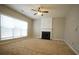 Spacious living room with neutral carpet, fireplace, and ceiling fan at 3936 Toccoa Falls Dr, Duluth, GA 30097