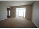Living room with a bay window, neutral carpet and paint. View of the front door at 3936 Toccoa Falls Dr, Duluth, GA 30097