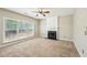 Cozy living room with a fireplace, ceiling fan, and large windows with blinds for ample light at 3936 Toccoa Falls Dr, Duluth, GA 30097