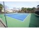 Well-maintained tennis courts feature vibrant blue and green surfaces, surrounded by mature trees and greenery at 3936 Toccoa Falls Dr, Duluth, GA 30097