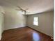 Comfortable bedroom featuring rich hardwood floors and a ceiling fan at 728 Slew Ave, Lawrenceville, GA 30043