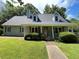 Charming single-Gathering home with a well-manicured lawn and covered front porch at 728 Slew Ave, Lawrenceville, GA 30043