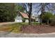 Home featuring an attached garage, neutral siding, and a green front yard at 728 Slew Ave, Lawrenceville, GA 30043