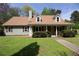 Traditional-style home with a covered porch and well-maintained lawn at 728 Slew Ave, Lawrenceville, GA 30043