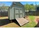 Neutral siding on the storage shed, complemented by the adjacent grass and wooden fence at 728 Slew Ave, Lawrenceville, GA 30043