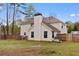 Spacious backyard featuring a wooden fence and mature trees, offering a private outdoor space for leisure at 130 Arbor Cove Way, Stockbridge, GA 30281