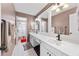 Bathroom showcasing double sinks, a white vanity, tile floors, and modern lighting fixtures at 130 Arbor Cove Way, Stockbridge, GA 30281