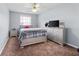 Bedroom featuring plush carpet, a ceiling fan, and a window that provides natural light at 130 Arbor Cove Way, Stockbridge, GA 30281