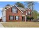 Beautiful two-story brick home with attached garage, a well-maintained lawn, and mature trees at 130 Arbor Cove Way, Stockbridge, GA 30281