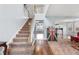 Grand foyer featuring a staircase, hardwood floors, and a view into the living and kitchen areas at 130 Arbor Cove Way, Stockbridge, GA 30281