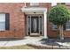 Elegant front door with decorative glass and sidelights, complemented by brick facade and landscaping at 130 Arbor Cove Way, Stockbridge, GA 30281