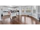 Open-concept kitchen with an island, hardwood floors, and white cabinets at 130 Arbor Cove Way, Stockbridge, GA 30281