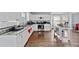 Bright, updated kitchen with stainless steel appliances, white cabinets, and hardwood floors at 130 Arbor Cove Way, Stockbridge, GA 30281