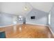 Spacious living room with hardwood floors, vaulted ceiling, fan, and access to the backyard at 130 Arbor Cove Way, Stockbridge, GA 30281
