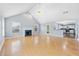 Open-concept living room featuring a fireplace, hardwood floors, lots of light and connection to the kitchen at 130 Arbor Cove Way, Stockbridge, GA 30281