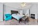 Main bedroom with vaulted ceilings, a ceiling fan, a seating area, and a fireplace at 130 Arbor Cove Way, Stockbridge, GA 30281