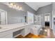 Bright bathroom with a soaking tub, a walk-in shower, wood flooring, and a dual sink vanity at 3986 Harmony Walk Se Way, Smyrna, GA 30082