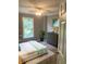 Cozy bedroom featuring a comfortable bed, neutral walls, and a large window at 3986 Harmony Walk Se Way, Smyrna, GA 30082