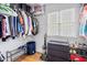 Walk-in closet with shelving for clothes, shoes, and boxes, plus a small chest of drawers at 3986 Harmony Walk Se Way, Smyrna, GA 30082