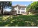 Exterior view of a house from the backyard with a spacious deck and lush green lawn at 3986 Harmony Walk Se Way, Smyrna, GA 30082