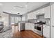 Modern kitchen with stainless steel appliances, white cabinets, and granite countertops at 3986 Harmony Walk Se Way, Smyrna, GA 30082