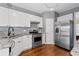 Kitchen featuring stainless steel appliances, white cabinets, and granite countertops at 3986 Harmony Walk Se Way, Smyrna, GA 30082