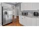 Kitchen featuring white cabinets, stainless steel refrigerator and microwave, with granite countertops at 3986 Harmony Walk Se Way, Smyrna, GA 30082