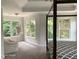 Spacious main bedroom featuring large windows, tray ceiling, and a stylish four-poster bed at 3986 Harmony Walk Se Way, Smyrna, GA 30082
