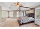 This bedroom features a four-poster bed, neutral walls, tray ceiling, and multiple windows for plenty of natural light at 3986 Harmony Walk Se Way, Smyrna, GA 30082
