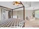 Spacious main bedroom with a four-post bed, trey ceilings and a sitting area by the window at 3986 Harmony Walk Se Way, Smyrna, GA 30082