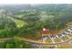 Drone shot of a home nestled near a lush forest and golf course, showcasing a desirable location at 1011 Ridgeview Rd, Woodstock, GA 30188