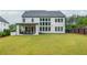Expansive backyard featuring a covered patio and lush green grass, perfect for outdoor enjoyment at 1011 Ridgeview Rd, Woodstock, GA 30188