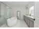 Bright bathroom with a soaking tub, marble floors, a glass shower, and dual sinks offering a spa-like experience at 1011 Ridgeview Rd, Woodstock, GA 30188