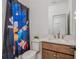 bathroom with cute shower curtain and wooden vanity with sink, creating a fun and functional space at 1011 Ridgeview Rd, Woodstock, GA 30188