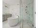 Open bathroom featuring a glass shower with tile surround, soaking tub, and double vanity, blending style and comfort at 1011 Ridgeview Rd, Woodstock, GA 30188