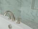 Modern bathtub faucet and controls against a marble tile surround creating a spa-like bathroom experience at 1011 Ridgeview Rd, Woodstock, GA 30188