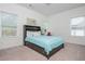 Bright bedroom with a desk, comfortable bed, and natural light, creating a cozy and functional living space at 1011 Ridgeview Rd, Woodstock, GA 30188