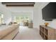Spacious bedroom with wood beam ceiling, and a comfortable seating area with natural light at 1011 Ridgeview Rd, Woodstock, GA 30188