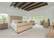 Spacious bedroom with wood beam ceiling, and a comfortable seating area with natural light at 1011 Ridgeview Rd, Woodstock, GA 30188