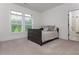 Bright, carpeted bedroom features two windows with a view of trees, and an ensuite bath at 1011 Ridgeview Rd, Woodstock, GA 30188