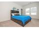 Bright bedroom with neutral colors featuring a bed with built-in bookcase headboard and natural light at 1011 Ridgeview Rd, Woodstock, GA 30188