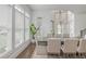 Bright dining room with large windows, hardwood floors and a wooden table with neutral-colored chairs at 1011 Ridgeview Rd, Woodstock, GA 30188