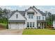 Charming white brick home with lush green lawn and a two car garage with inviting curb appeal at 1011 Ridgeview Rd, Woodstock, GA 30188